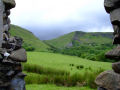 Antrim Countryside (Green hills viewed through gap in stone wall)