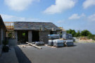 Building Site 7 (Shell of house with some roof tiles on the rafters).